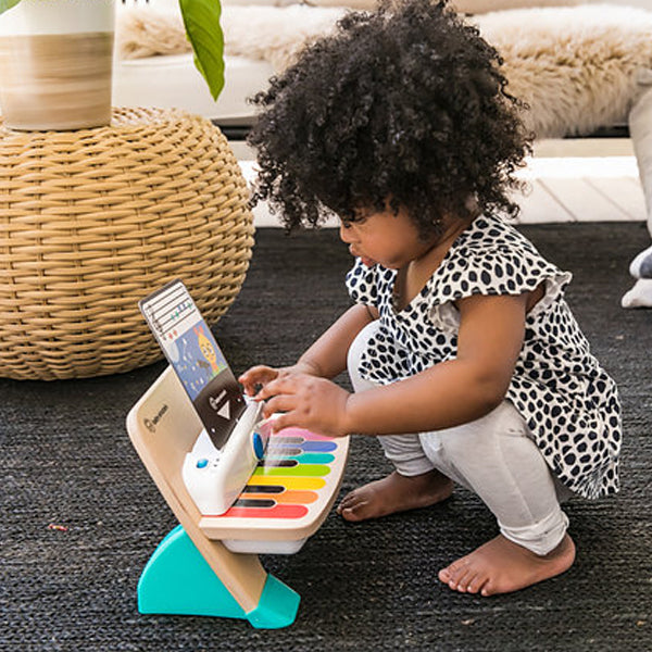 baby einstein young girl playing a toy piano