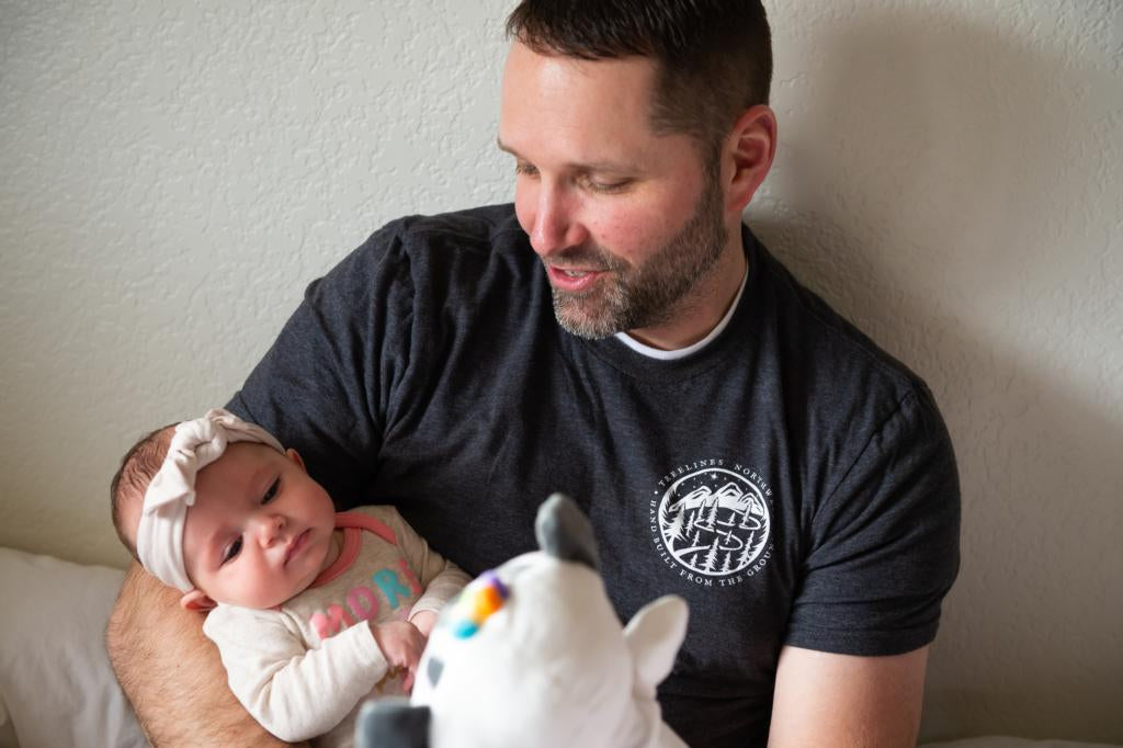 dad and baby play with Zen Zebra Puppet