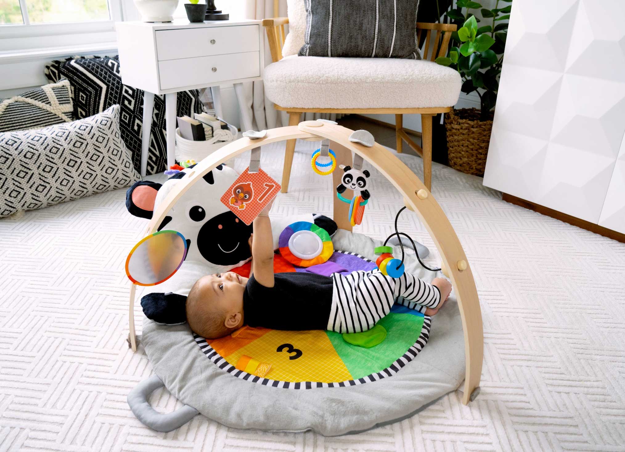 child playing with baby einstein product