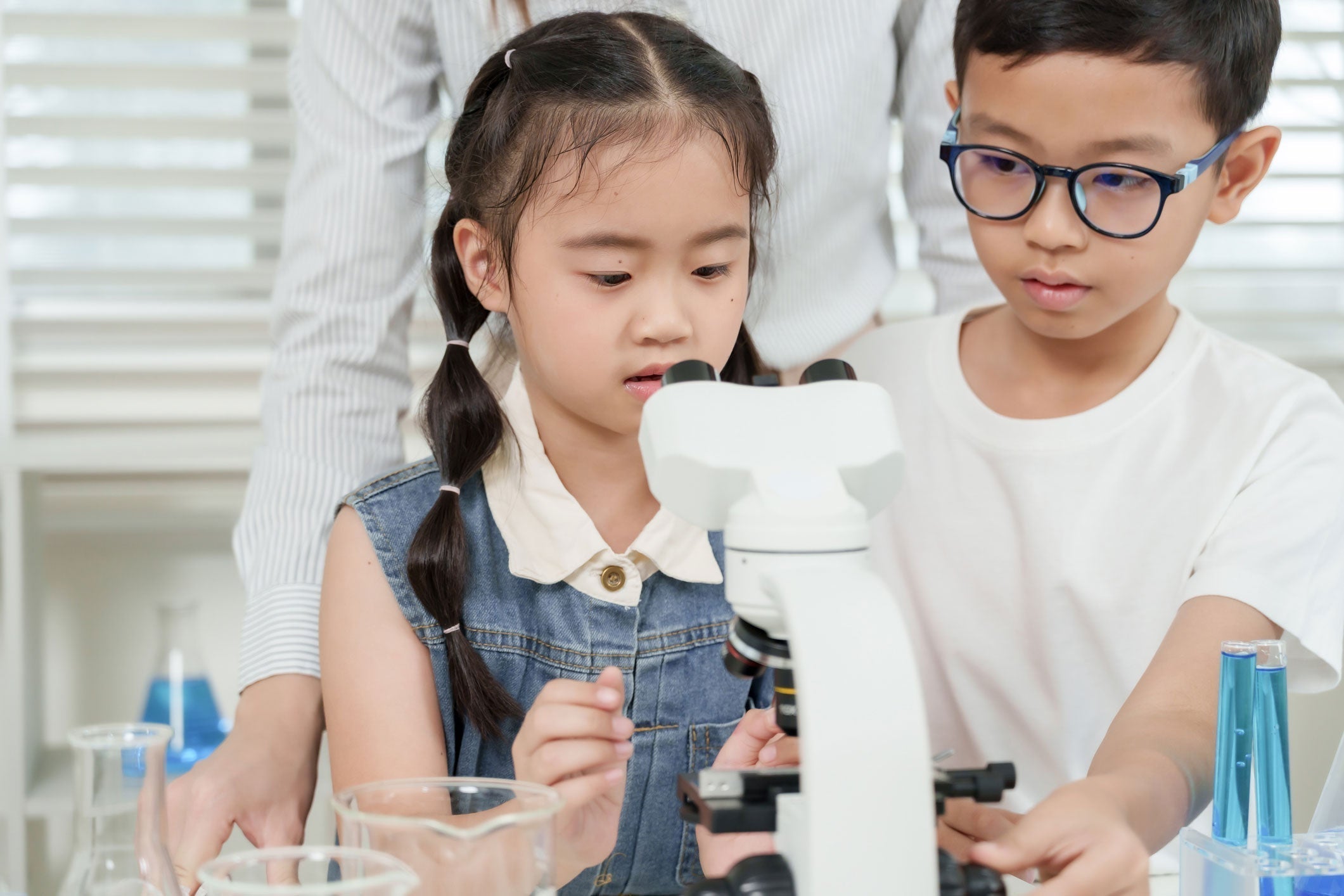 boy and girl using a microscope