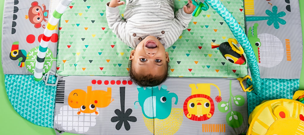 baby looking at a play gym