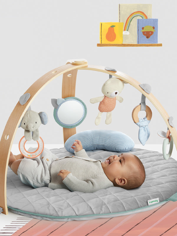 baby in ingenuity play gym