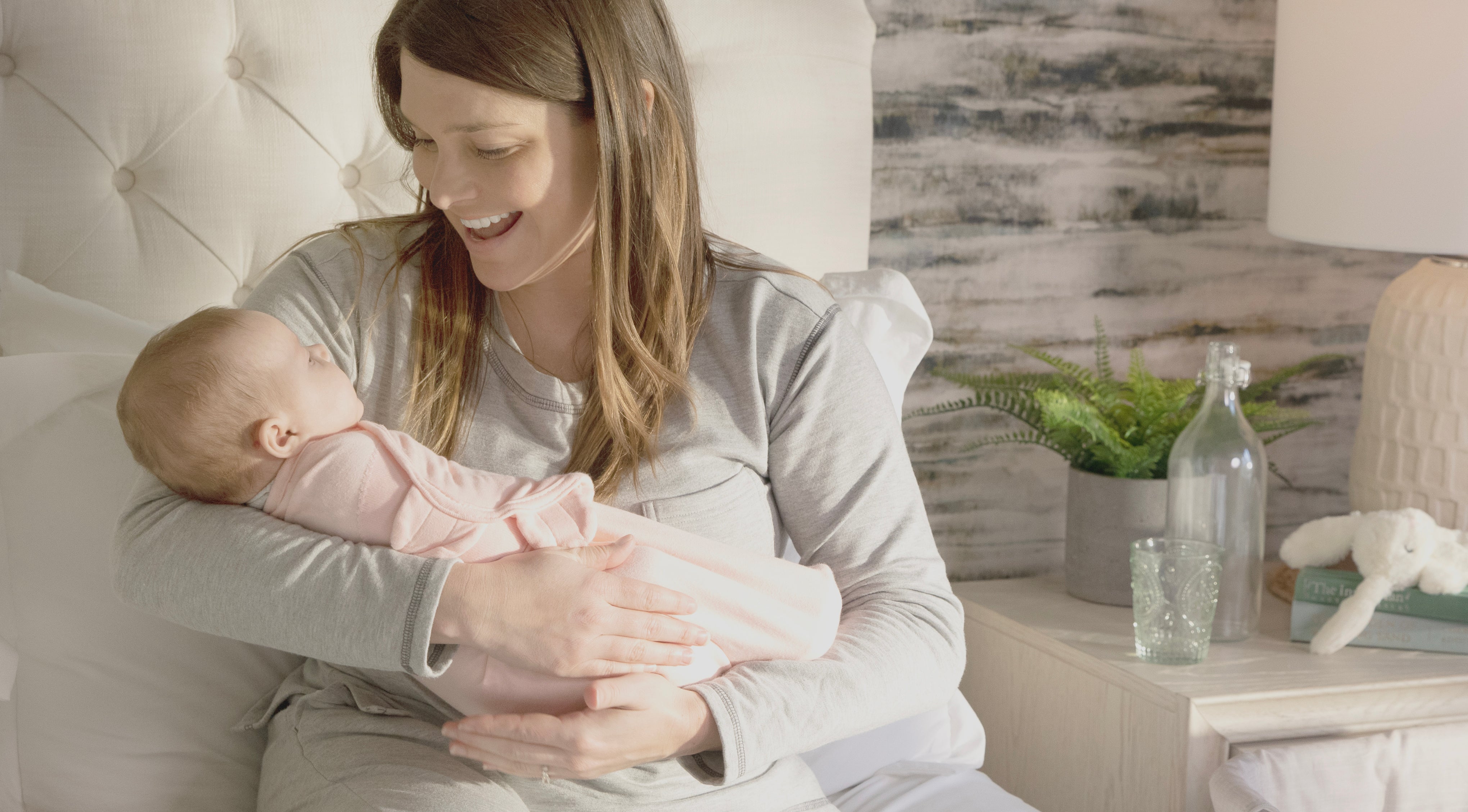 woman holding a baby in a swaddle
