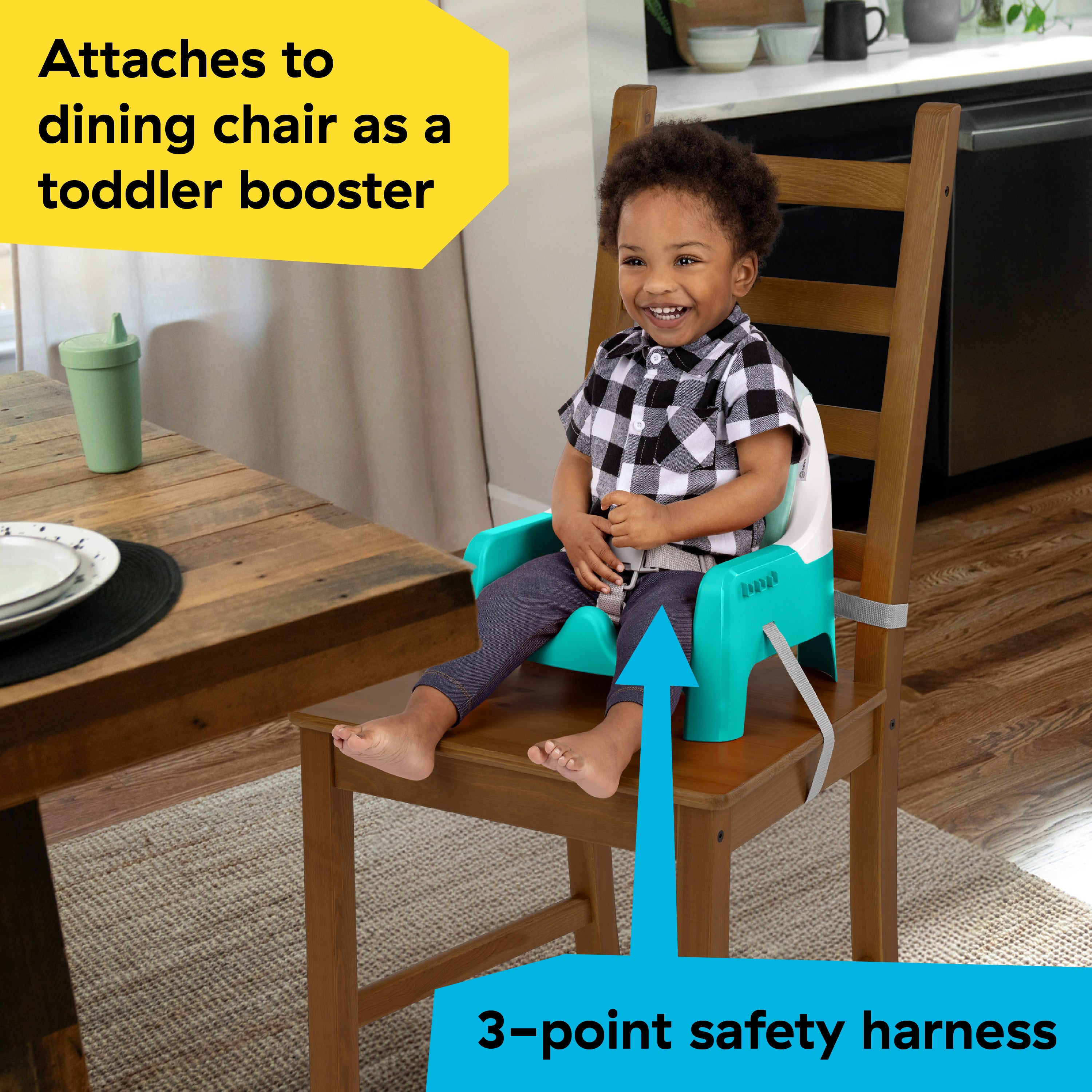 Toddler booster seat attached to chair at table